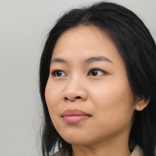 Joyful asian young-adult female with long  black hair and brown eyes