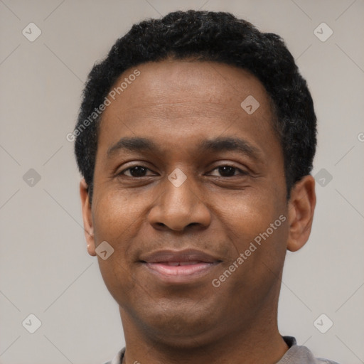 Joyful black young-adult male with short  black hair and brown eyes