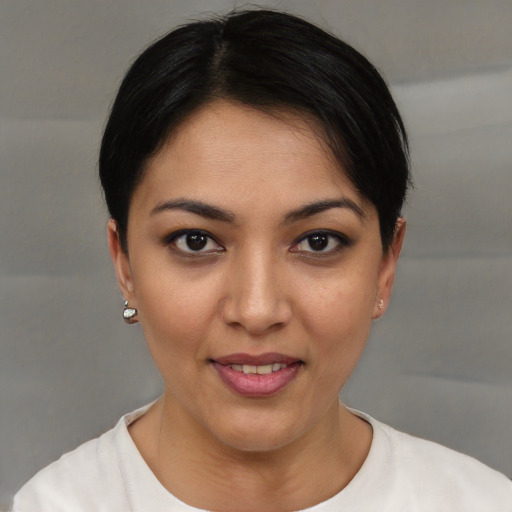 Joyful latino young-adult female with short  brown hair and brown eyes