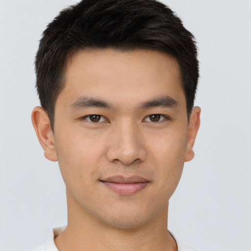 Joyful asian young-adult male with short  brown hair and brown eyes