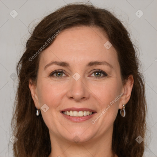 Joyful white adult female with long  brown hair and green eyes