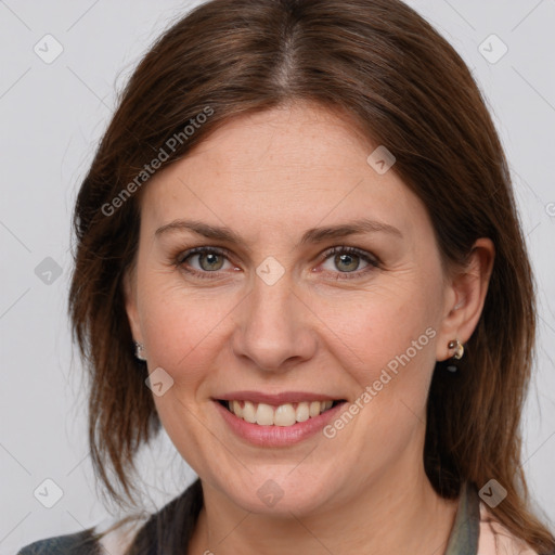 Joyful white adult female with medium  brown hair and grey eyes