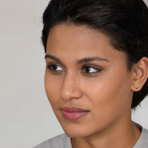 Joyful asian young-adult female with short  brown hair and brown eyes