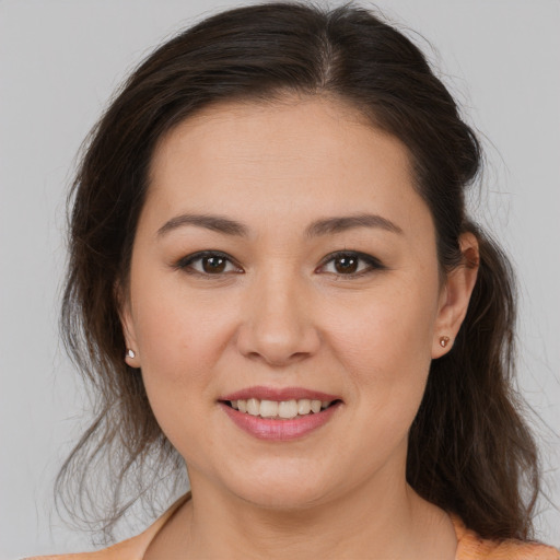 Joyful white young-adult female with medium  brown hair and brown eyes