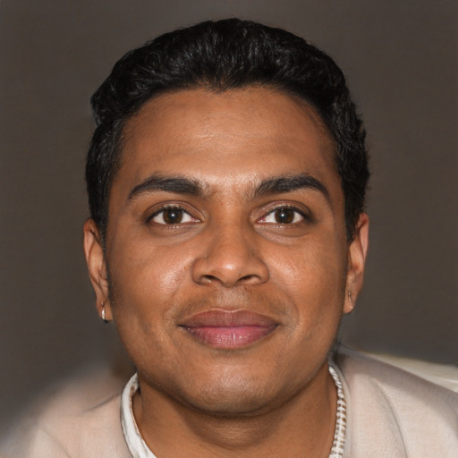 Joyful black young-adult male with short  brown hair and brown eyes