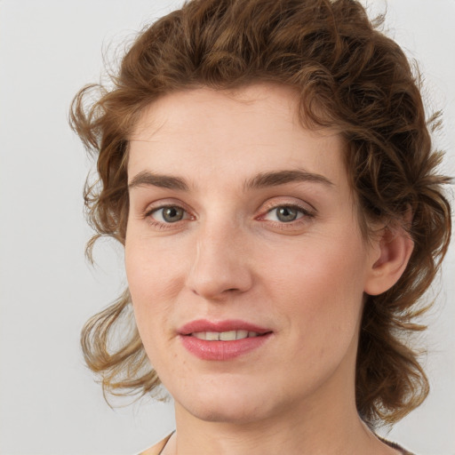 Joyful white young-adult female with medium  brown hair and green eyes