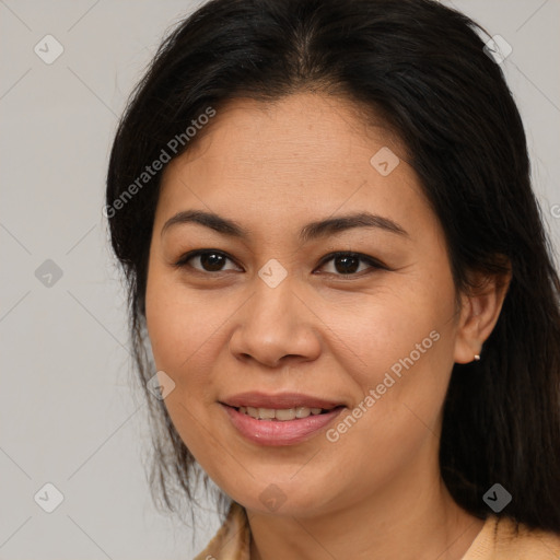 Joyful latino young-adult female with long  brown hair and brown eyes