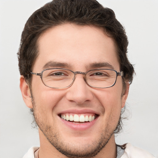 Joyful white adult male with short  brown hair and grey eyes