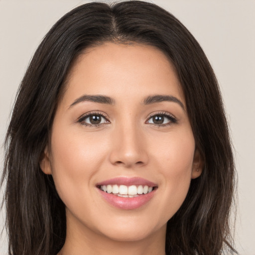 Joyful white young-adult female with long  brown hair and brown eyes