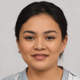 Joyful latino young-adult female with medium  brown hair and brown eyes