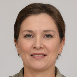 Joyful white adult female with medium  brown hair and grey eyes