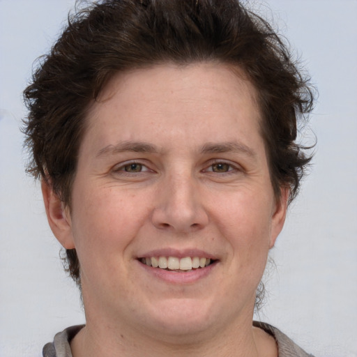 Joyful white adult female with short  brown hair and brown eyes