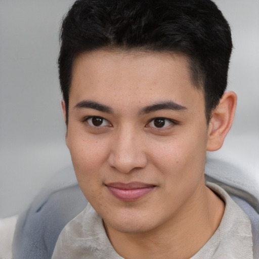Joyful asian young-adult male with short  brown hair and brown eyes