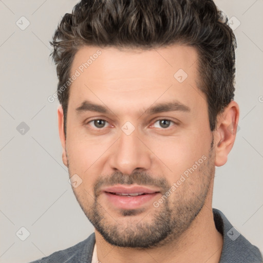 Joyful white young-adult male with short  black hair and brown eyes