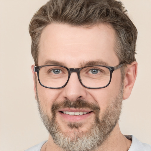 Joyful white adult male with short  brown hair and green eyes