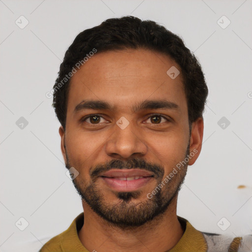 Joyful latino young-adult male with short  black hair and brown eyes