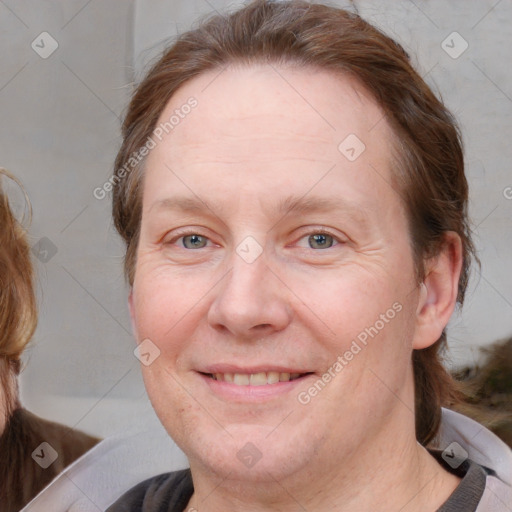 Joyful white adult female with medium  brown hair and blue eyes