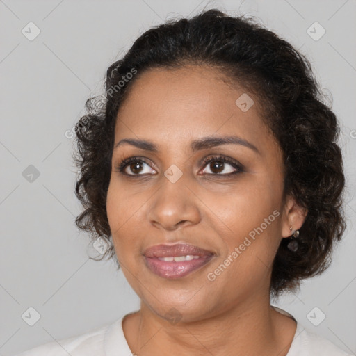 Joyful black young-adult female with medium  brown hair and brown eyes