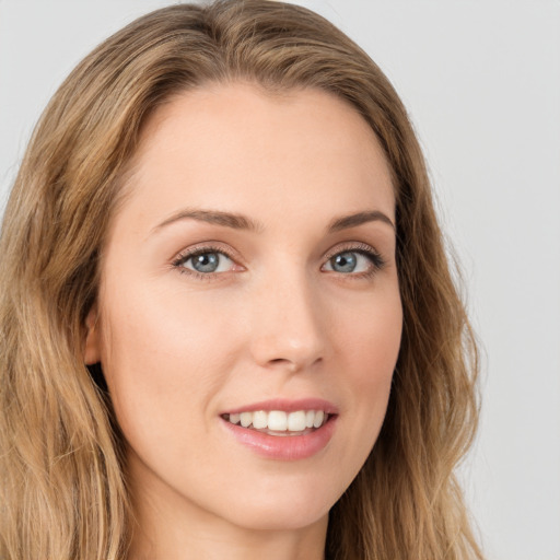 Joyful white young-adult female with long  brown hair and green eyes