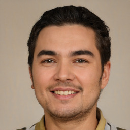 Joyful white young-adult male with short  black hair and brown eyes