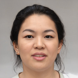 Joyful asian young-adult female with medium  brown hair and brown eyes