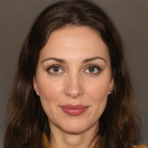 Joyful white adult female with long  brown hair and brown eyes