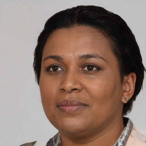 Joyful black adult female with medium  black hair and brown eyes