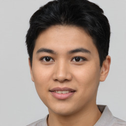 Joyful asian young-adult male with short  black hair and brown eyes