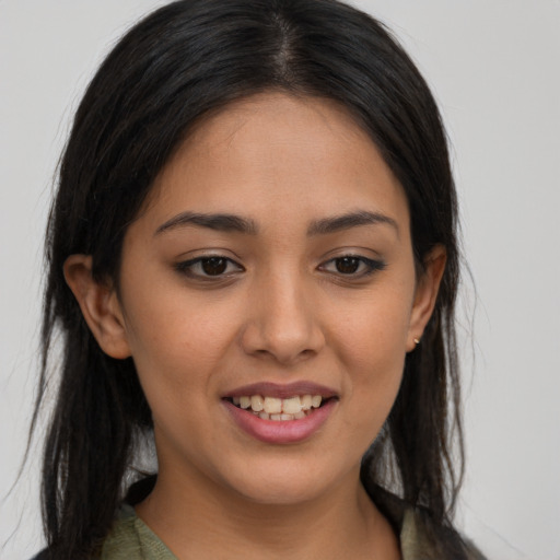 Joyful latino young-adult female with long  brown hair and brown eyes
