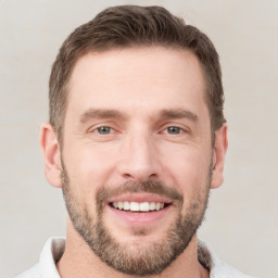 Joyful white young-adult male with short  brown hair and brown eyes