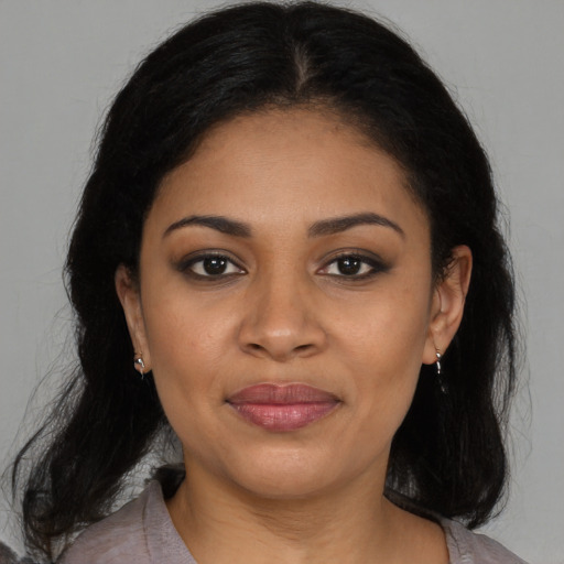 Joyful black young-adult female with medium  brown hair and brown eyes