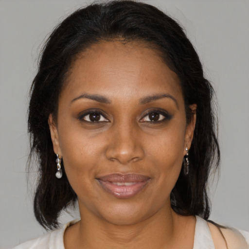 Joyful black young-adult female with medium  brown hair and brown eyes