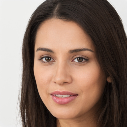 Joyful white young-adult female with long  brown hair and brown eyes