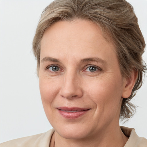 Joyful white adult female with medium  brown hair and grey eyes