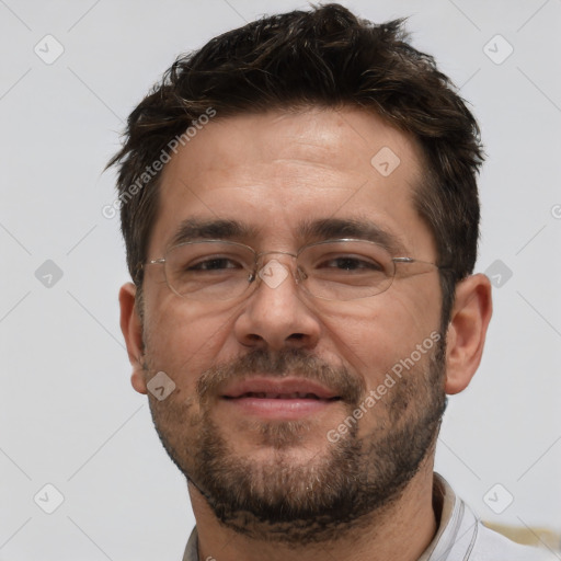 Joyful white adult male with short  brown hair and brown eyes