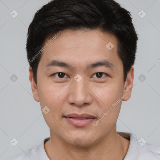 Joyful asian young-adult male with short  brown hair and brown eyes