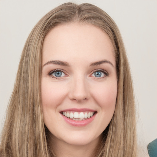 Joyful white young-adult female with long  brown hair and green eyes