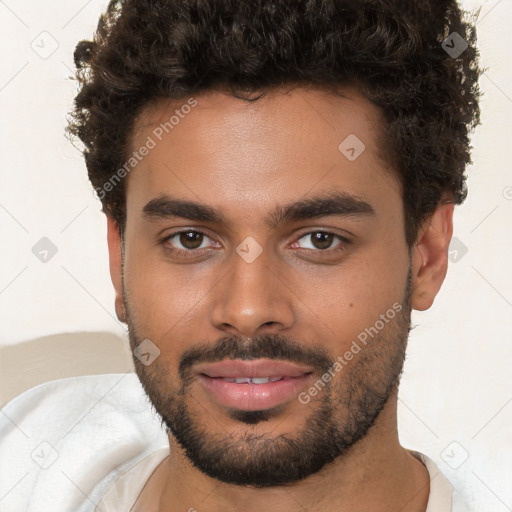 Joyful black young-adult male with short  brown hair and brown eyes