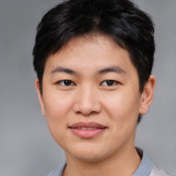 Joyful asian young-adult male with short  brown hair and brown eyes