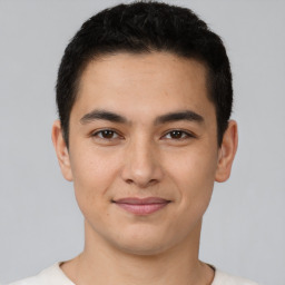 Joyful latino young-adult male with short  brown hair and brown eyes