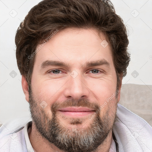 Joyful white adult male with short  brown hair and grey eyes