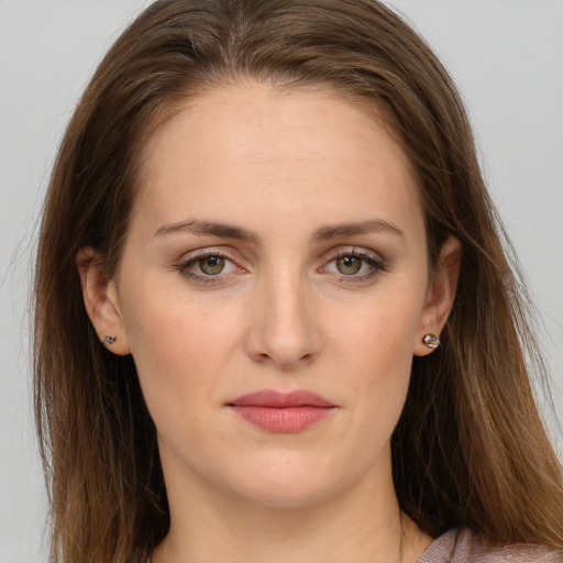 Joyful white young-adult female with long  brown hair and grey eyes