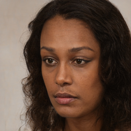 Neutral black young-adult female with long  brown hair and brown eyes