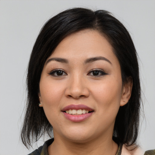 Joyful asian young-adult female with medium  brown hair and brown eyes