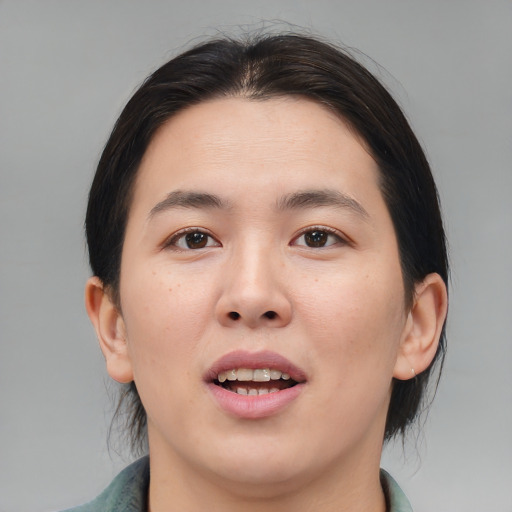 Joyful asian young-adult female with medium  brown hair and brown eyes