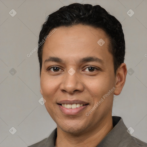 Joyful latino young-adult male with short  black hair and brown eyes