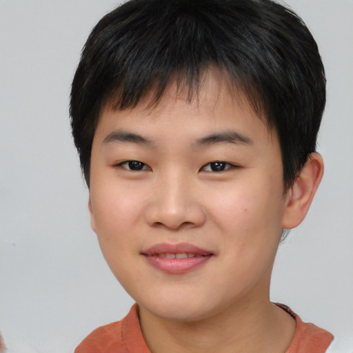 Joyful asian child male with short  brown hair and brown eyes