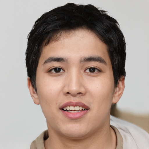Joyful asian young-adult male with short  black hair and brown eyes