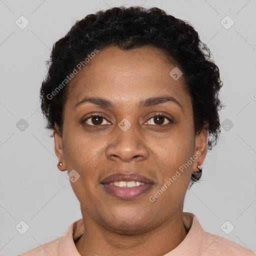 Joyful black young-adult female with short  black hair and brown eyes