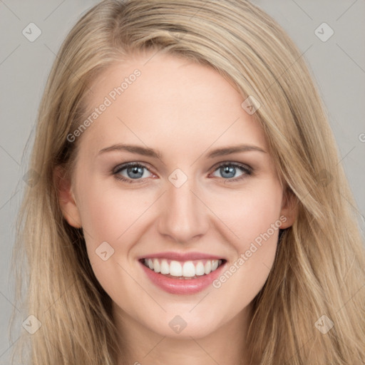 Joyful white young-adult female with long  brown hair and blue eyes